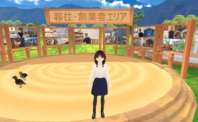 バーチャル空間のイベント会場で、アニメキャラクターが中央に立っています。「移住・創業者エリア」の看板と、移住や起業に関する情報が表示された複数のスクリーンが見えます。