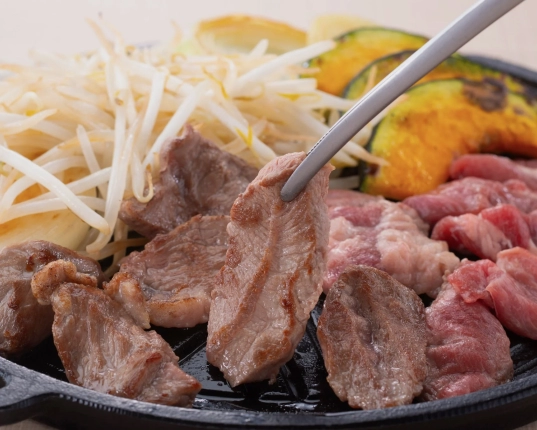 鉄板の上で焼かれている羊肉や野菜